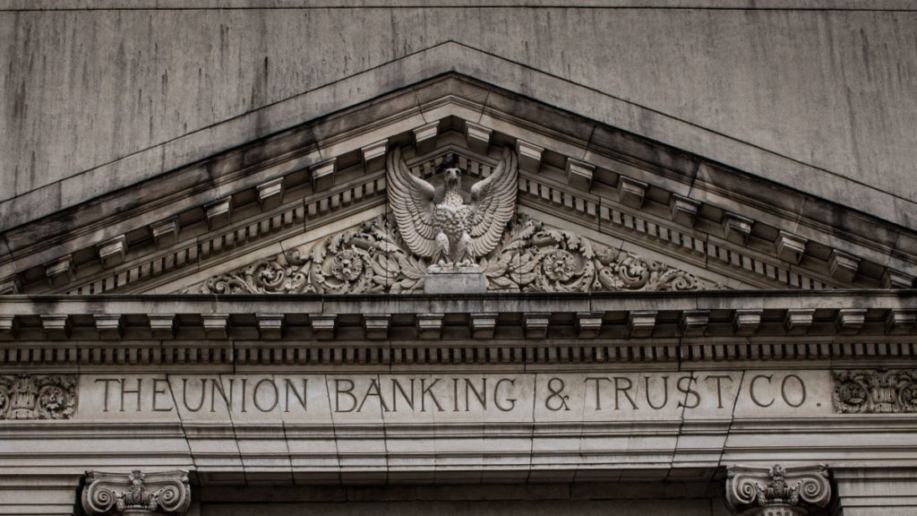 A marble building facade reads The Union Banking & Trust Co.