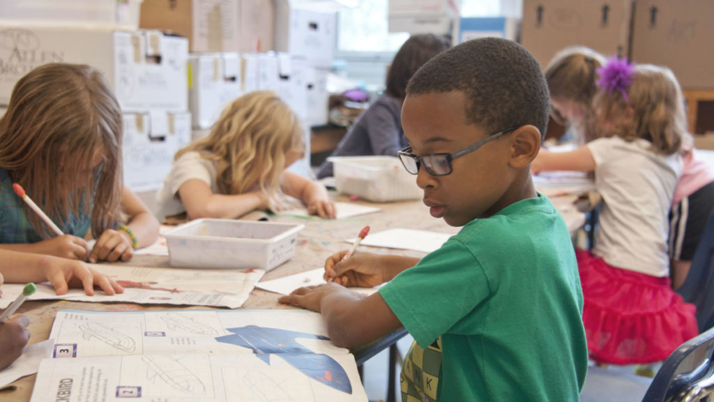 Children work on a science project in their classroom. Ensuring equitable broadband access for all children is imperative.