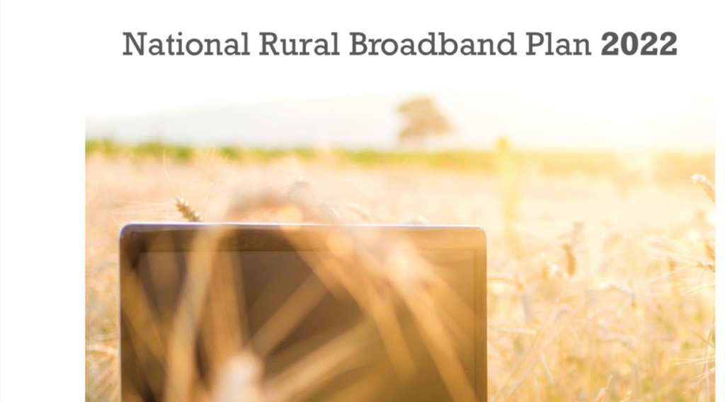 National Rural Broadband Plan 2022; image of a laptop in a field of yellow grass.